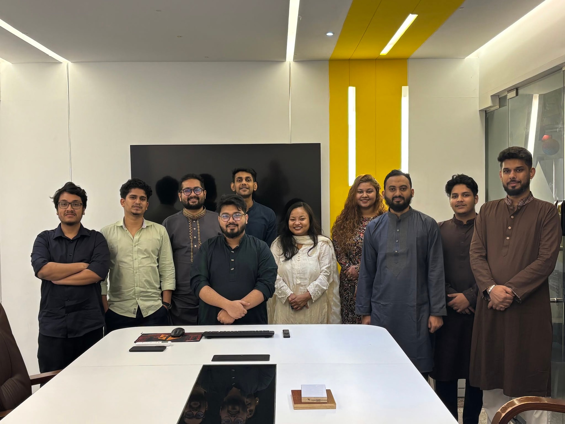 IMPIT team in traditional panjabi and festive wear celebrating Eid ul-Adha in the office