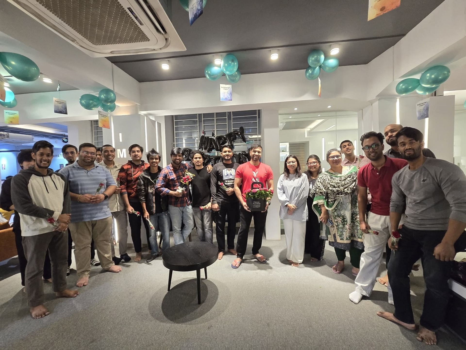 IMPIT team holding roses and balloons during the International Men's Day celebration