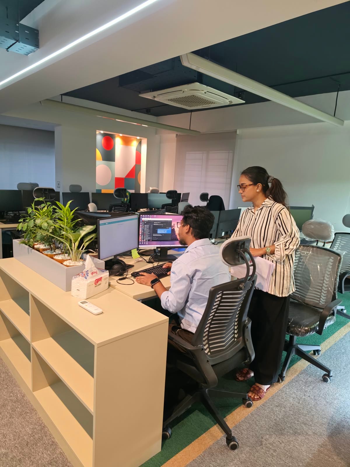 IMPIT colleagues reviewing work together at a desk