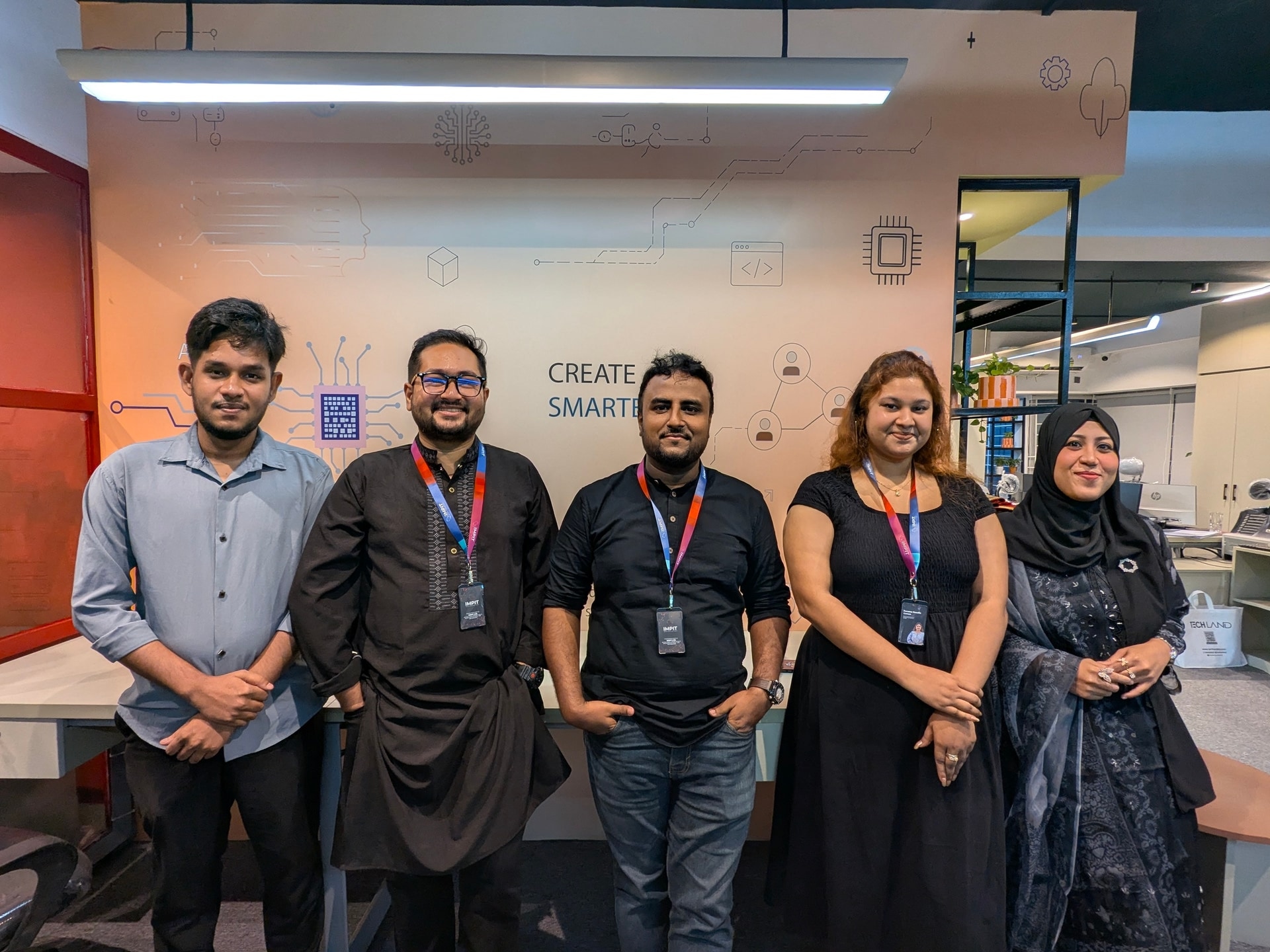 IMPIT team members standing together in the office